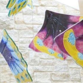 Close up of artwork made from brightly coloured glass.