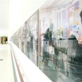 Corridor with wall of artwork.