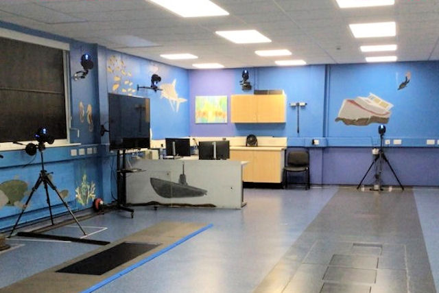 Spacious room with shiny floor and camera equipment at edges