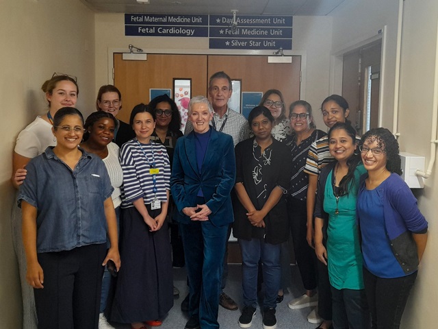 Group of 14 people in front of a sign that says 'Fetal Maternal Medicine Unit'