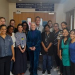 Group of 14 people in front of a sign that says 'Fetal Maternal Medicine Unit'