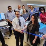 A group of people attending a ribbon-cutting ceremony 