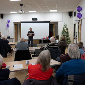 A room full of people looking at the presenter