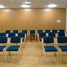 Interior of seminar room, set up with rows of chairs facing the front
