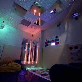 A dark room with lights and sensory equipment.