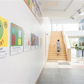Hospital corridor with brightly coloured posters.