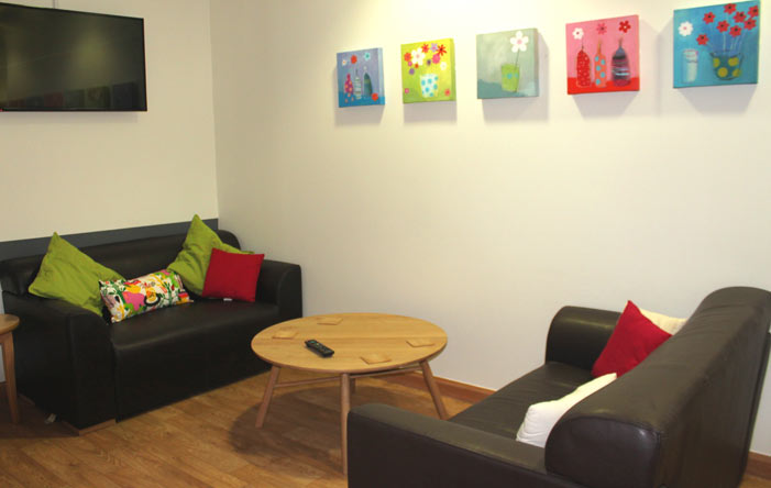 Parents room, with sofas, coffee table and paintings on the walls