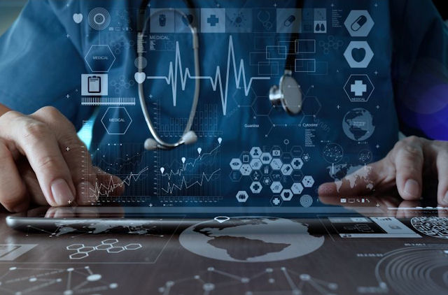 Clinician's hands on a horizontal digital screen display