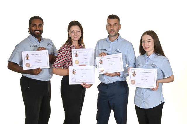 Four members of staff hold their certificates