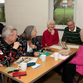 A table of delegates laughing