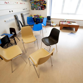 An empty waiting room with chairs grouped together.