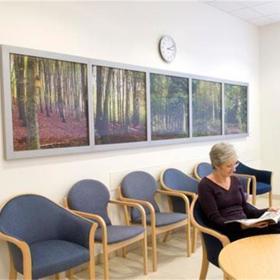 Room with row of artwork on the wall behind.