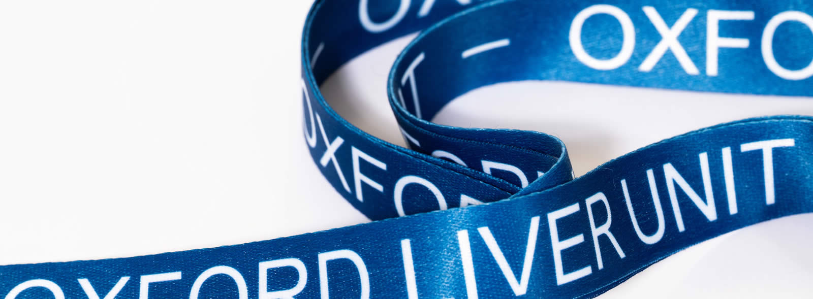 Curled lanyards with 'Oxford Liver Unit' on them