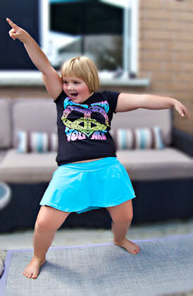 Little girl dancing wildly in a living room