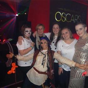 A group of people, some in fancy dress / wearing face paint.