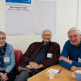 Attendees smiling and looking at the camera